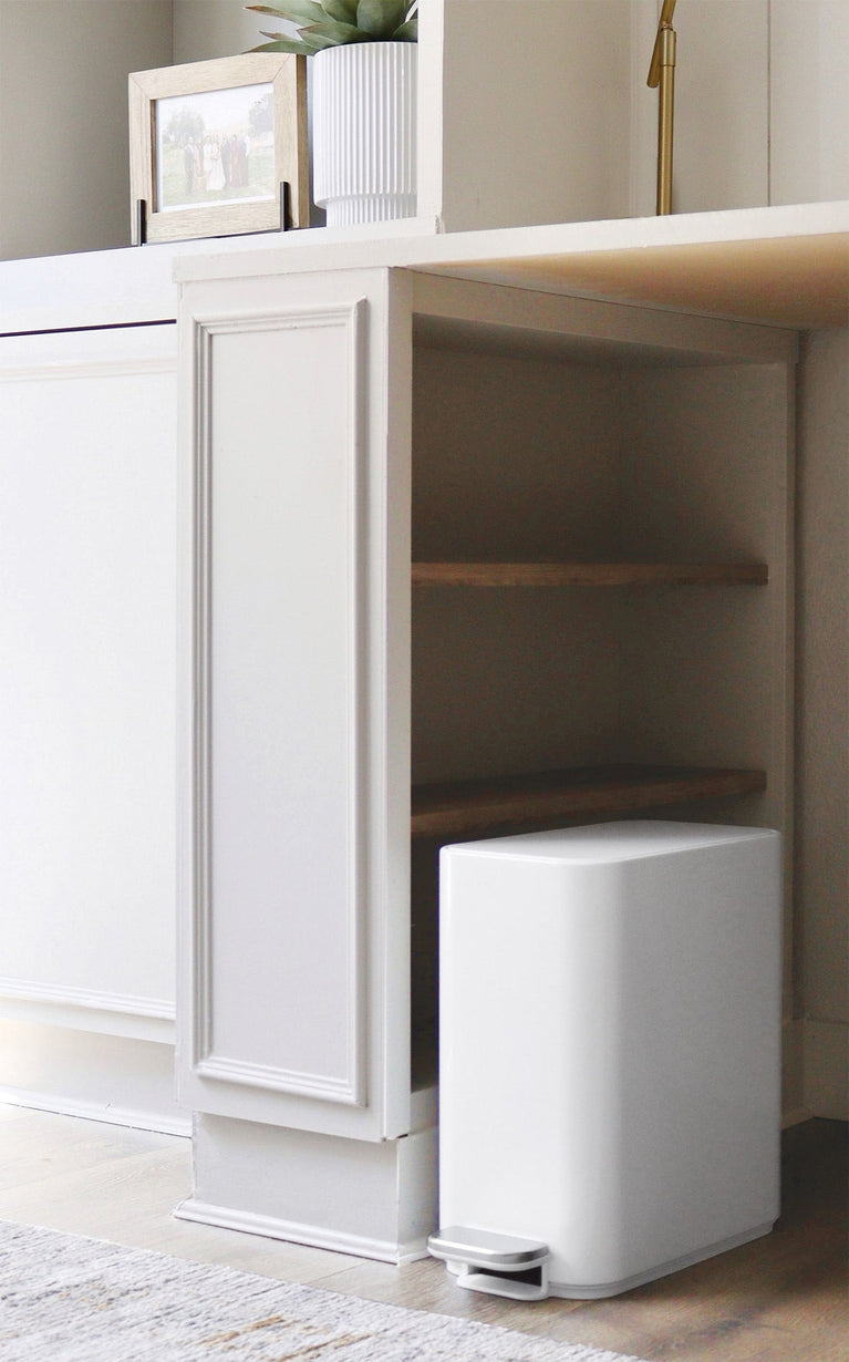 Simplehuman's Slim Mini Can in a modern cabinet setting. 
