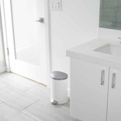 6L semi-round pedal bin - white finish - lifestyle in bathroom next to cabinet
