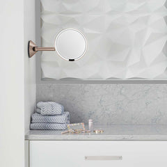 hard-wired wall mount sensor mirror - rose gold finish - lifestyle in bathroom image